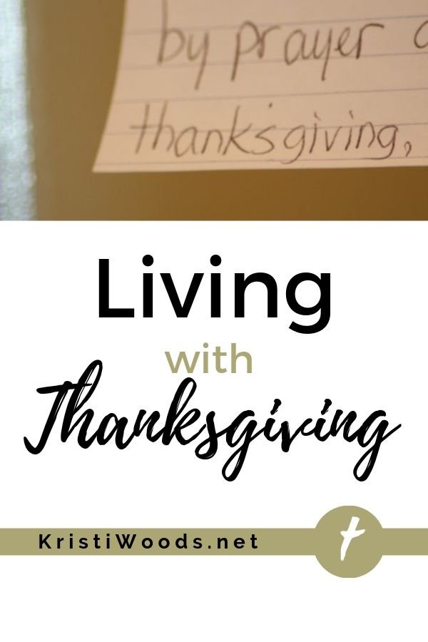 Index card with the word thanksgiving on it, underneath the Christian blog post title Living with Thanksgiving