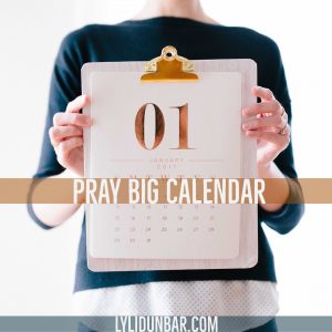 woman holding a calendar with the words "Pray Big Calendar" in front