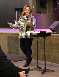 Kristi Woods speaking to a group in church