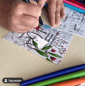 Woman coloring Bible coloring pages with markers