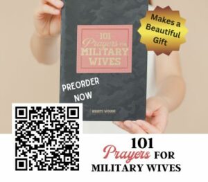 Woman holding a book called 101 Prayers for Military Wives by Kristi Woods, QR Code along with preorder now notice