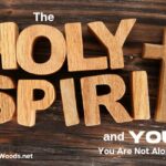 Christian Blog Post title with wooden letters for Holy Spirit and a wooden cross on a darker wooden background