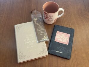 Christian mug, bookmark, journal, and 101 Prayers for Military Wives by Kristi Woods sitting on table
